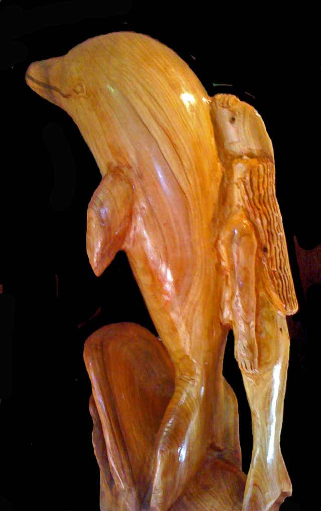 wood carving of a mermaid and a dolphin, mermaid hitching a ride on a dolphin, woodcarving of a mermaid riding a dolphin, sculpture of a mermaid and a dolphin